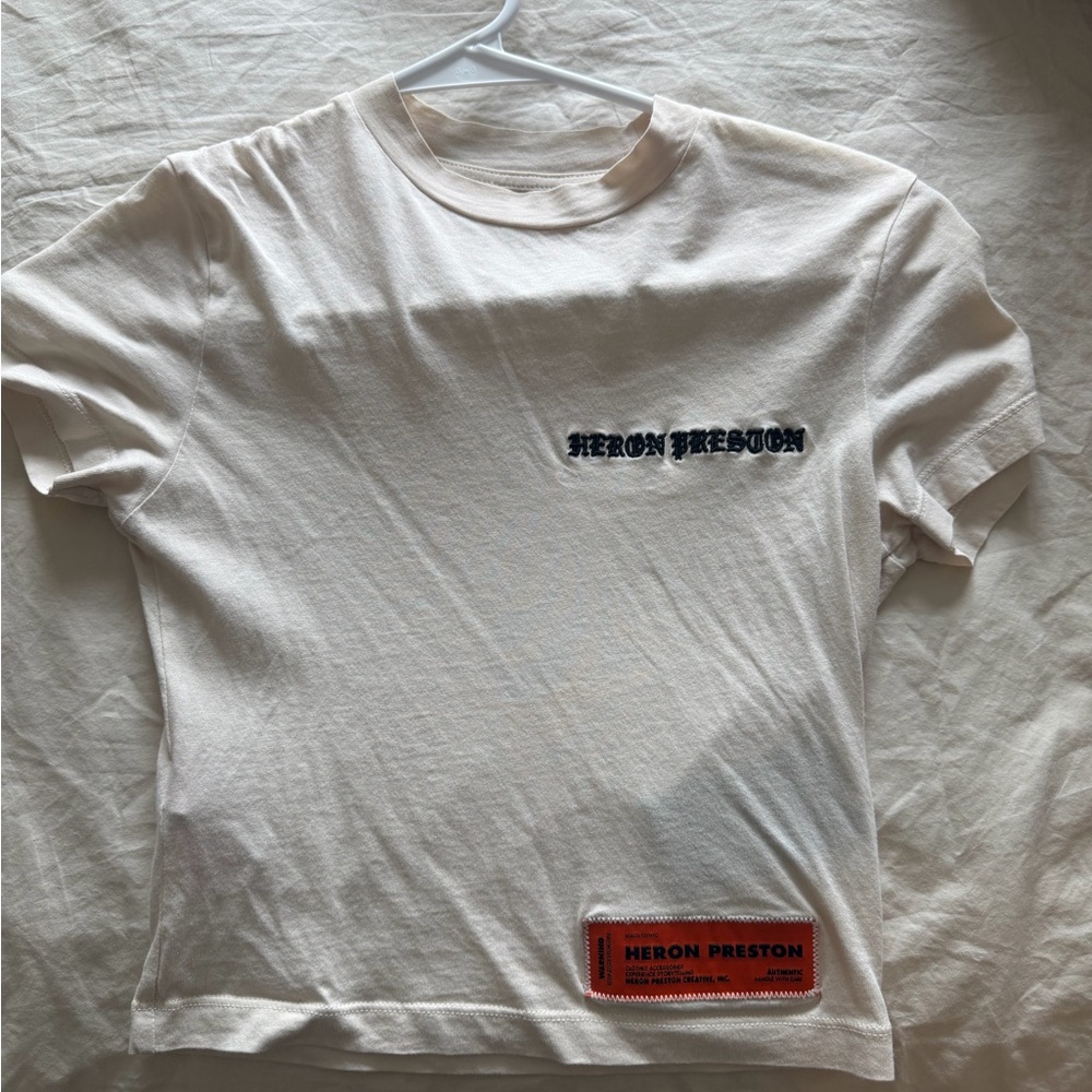 Heron Preston White Tee with Black Script and Orange Patch